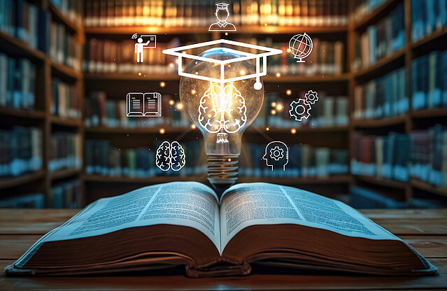 Open book with light bulb with graduation hat